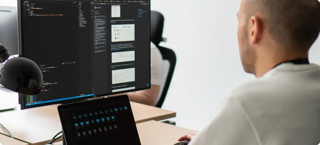 Individual engaged in coding on a laptop