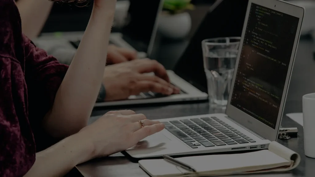 A woman at a desk using a laptop,
