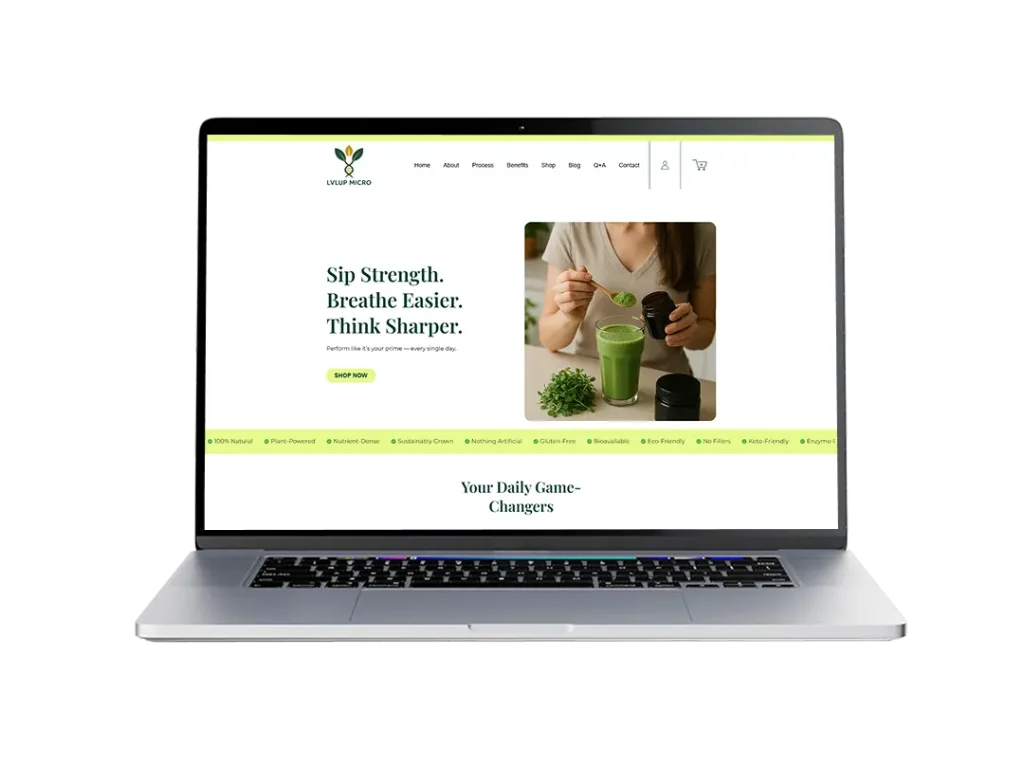 A laptop featuring a green smoothie on top,